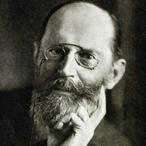 Fischer wearing pinch nose glasses resting his head on his hand