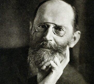 Fischer wearing pinch nose glasses resting his head on his hand