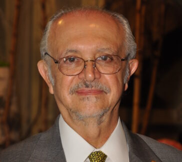 man dressed in a suit with a yellow tie