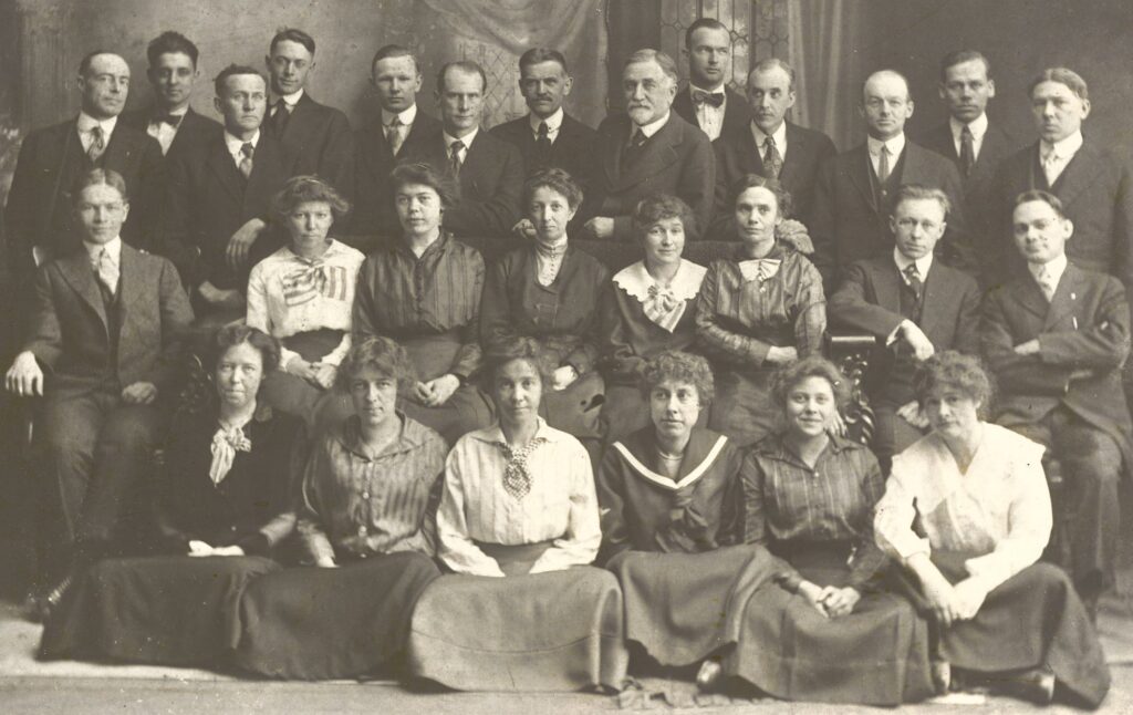 old photo of a group of men and women formally dressed