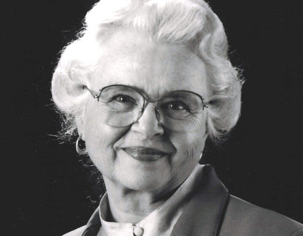 black and white photo of an older woman wearing glasses
