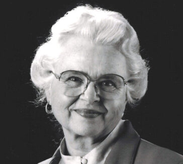 black and white photo of an older woman wearing glasses