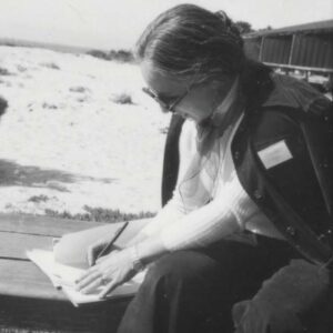 woman seated writing notes