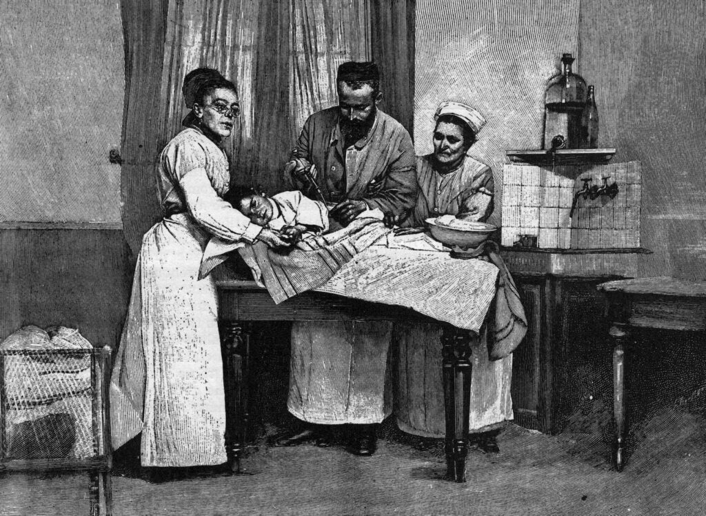 Man and two women with small child on table