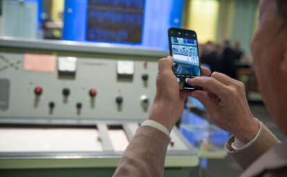 man taking a photo of an exhibit