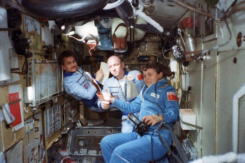 Three cosmonauts floating in space station