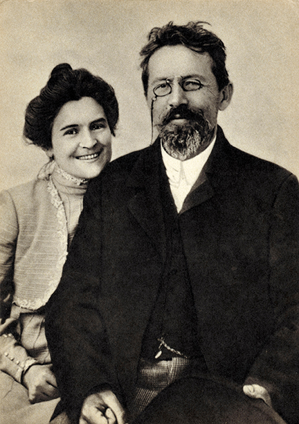 Olga Knipper-Chekhova and Anton Chekhov seated and smiling