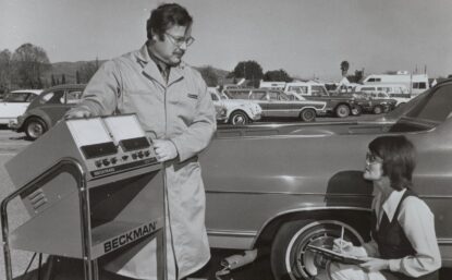 Lab workers testing car exhaust with a scientific instrument