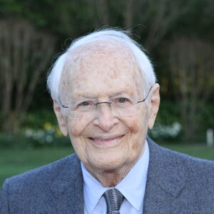 Rosenkranz in a suit and tie, smiling