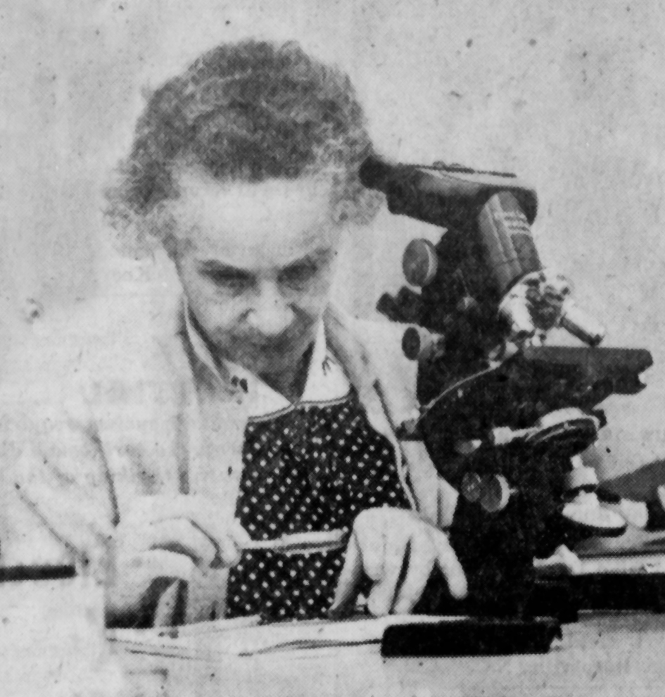 Newspaper photo of woman with microscope