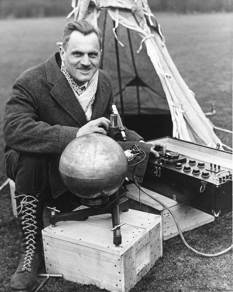 Man in heavy coat outdoors with scientific instruments