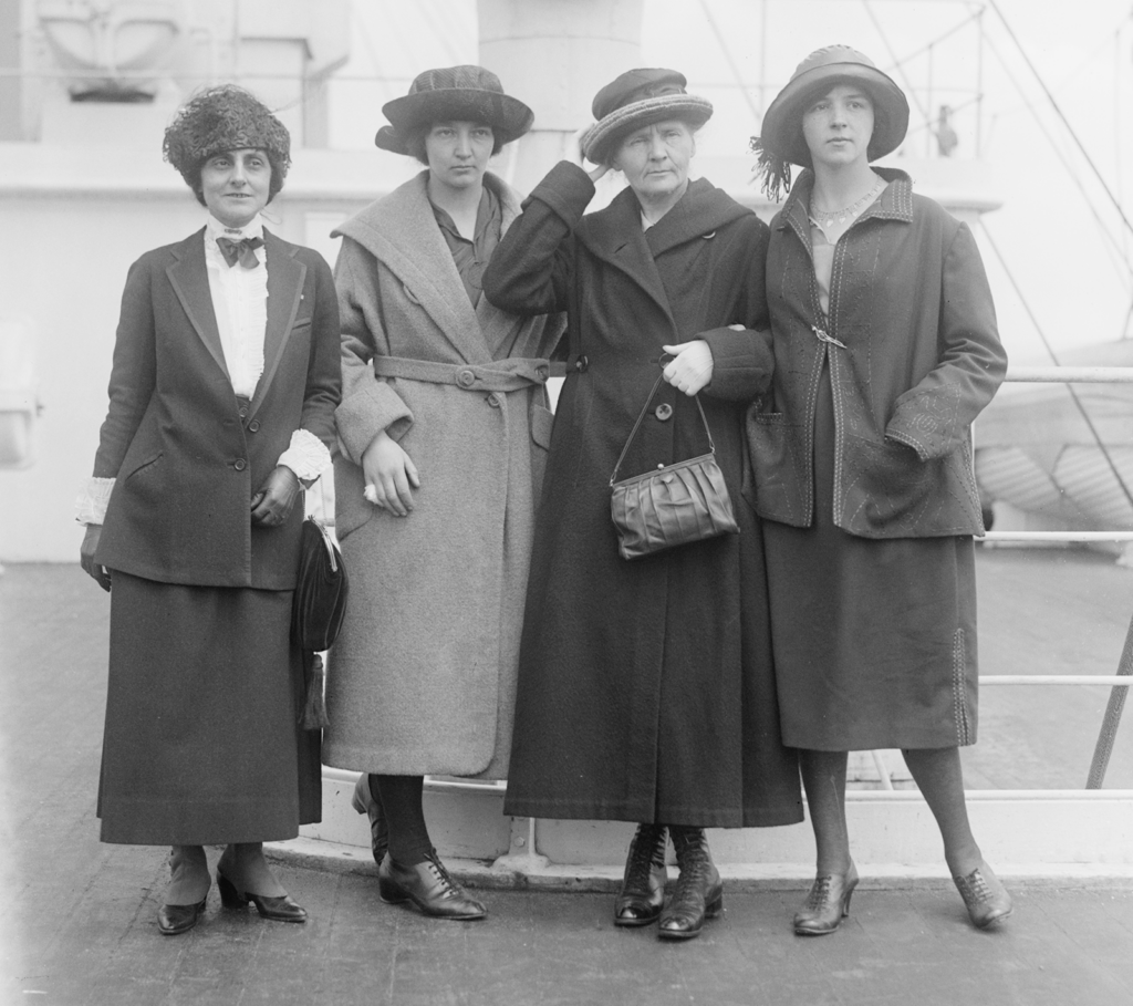 Meloney and Curies posing on the deck of a ship