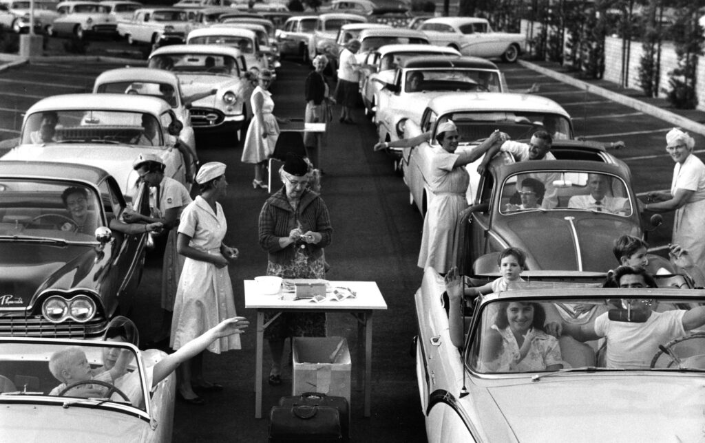 Cars lined up with nurses working