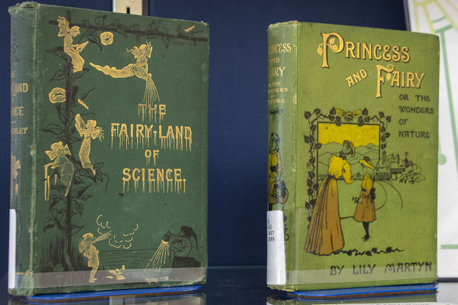 Two Fairy story science books, one a deep green with gold lettering and illustration and one is lime green with gold lettering and two female figures