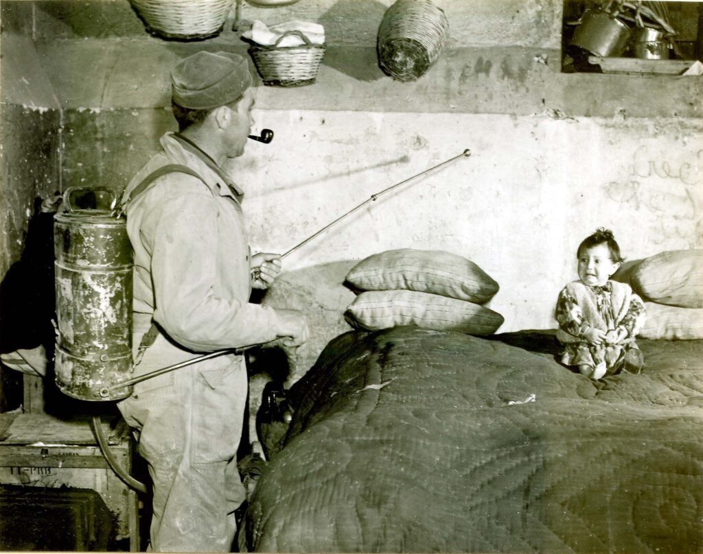 Soldier in an Italian home spraying a mixture of DDT and kerosene.