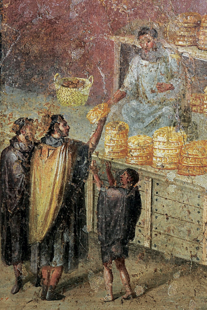 Color fresco showing man passing bread to another man