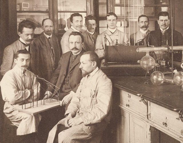 Group of men in old chemistry lab