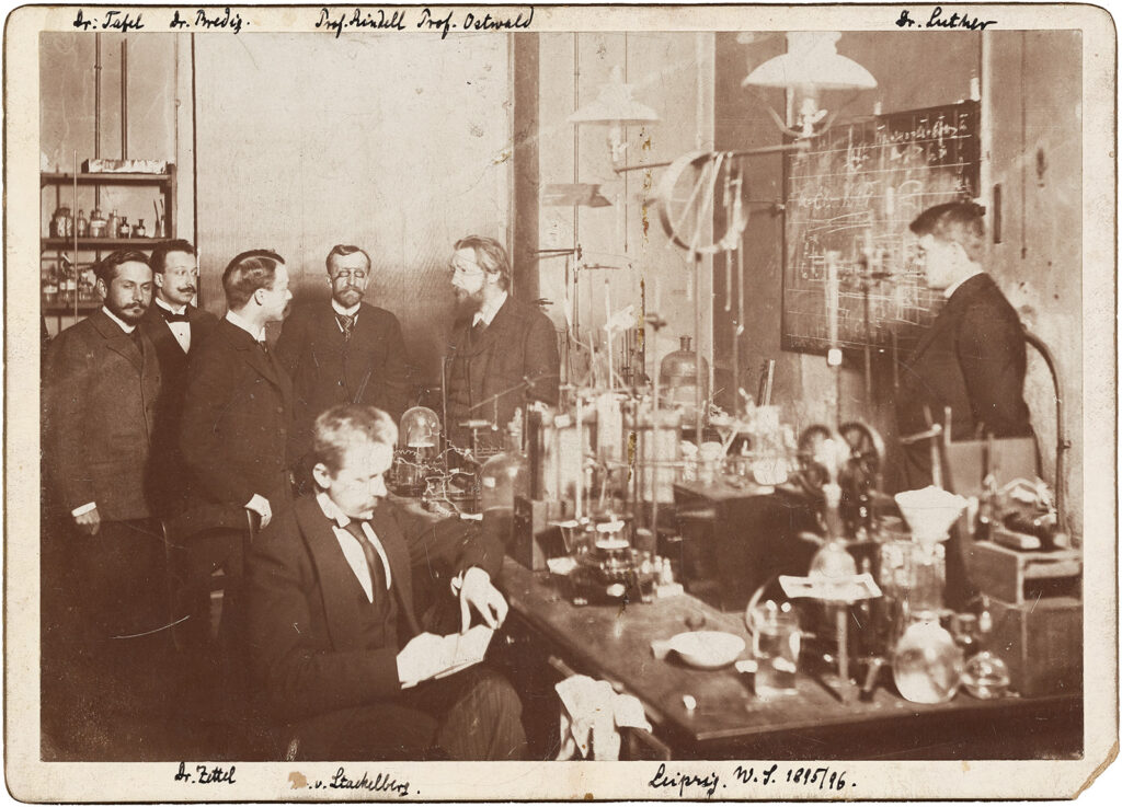 Men standing in an old chemistry lab