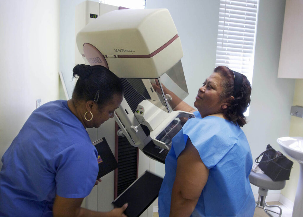 Clinical scene of a mammogram being given
