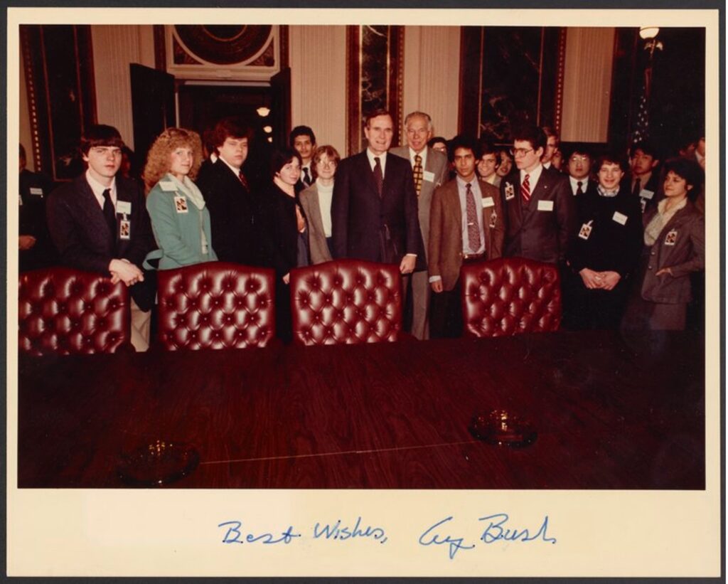Glenn Seaborg with George Bush and an unidentified group. The photo is in color and is signed "Best wishes, George Bush"