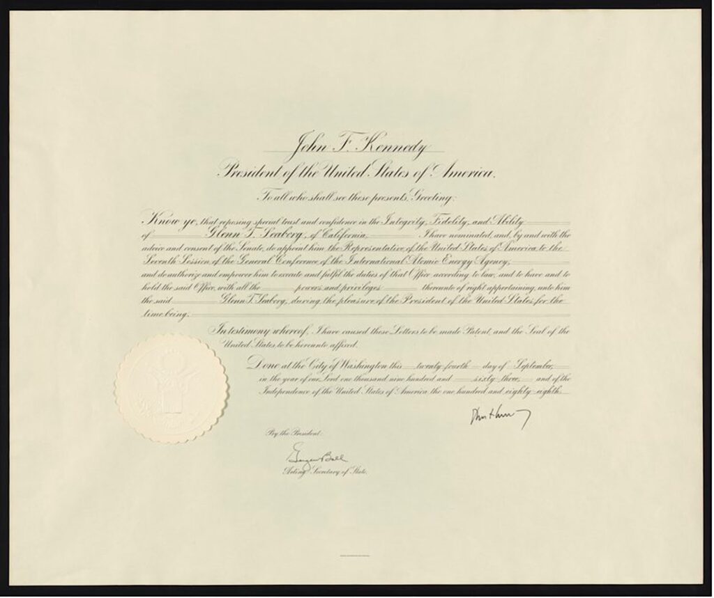 Appointment conferred by John F. Kennedy to Glenn Seaborg. It's a decorative document with cursive script and a seal.