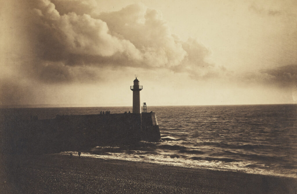 black and white photo of lighthouse and sea