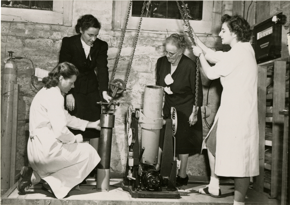 old photo of a group of women doing an experiment