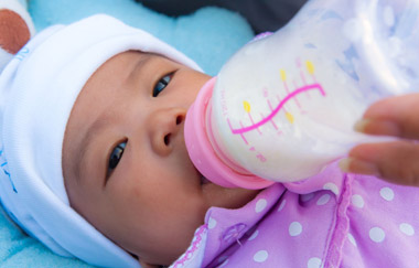 baby drinking milk from a bottle