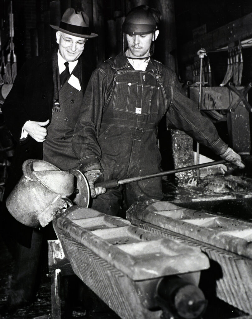 Photo of two men in industrial setting