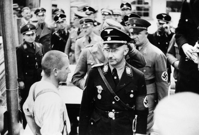 Heinrich Himmler standing with other Nazis