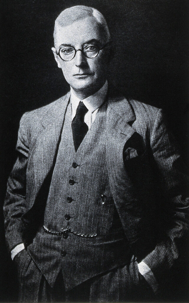 Black and white portrait of man in suit and glasses