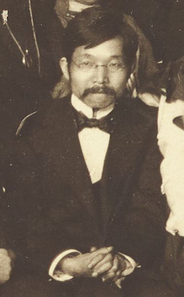 Black and white photo of seated man