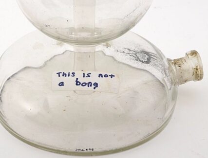 Glass vessel with handwritten label that reads "This is not a bong."