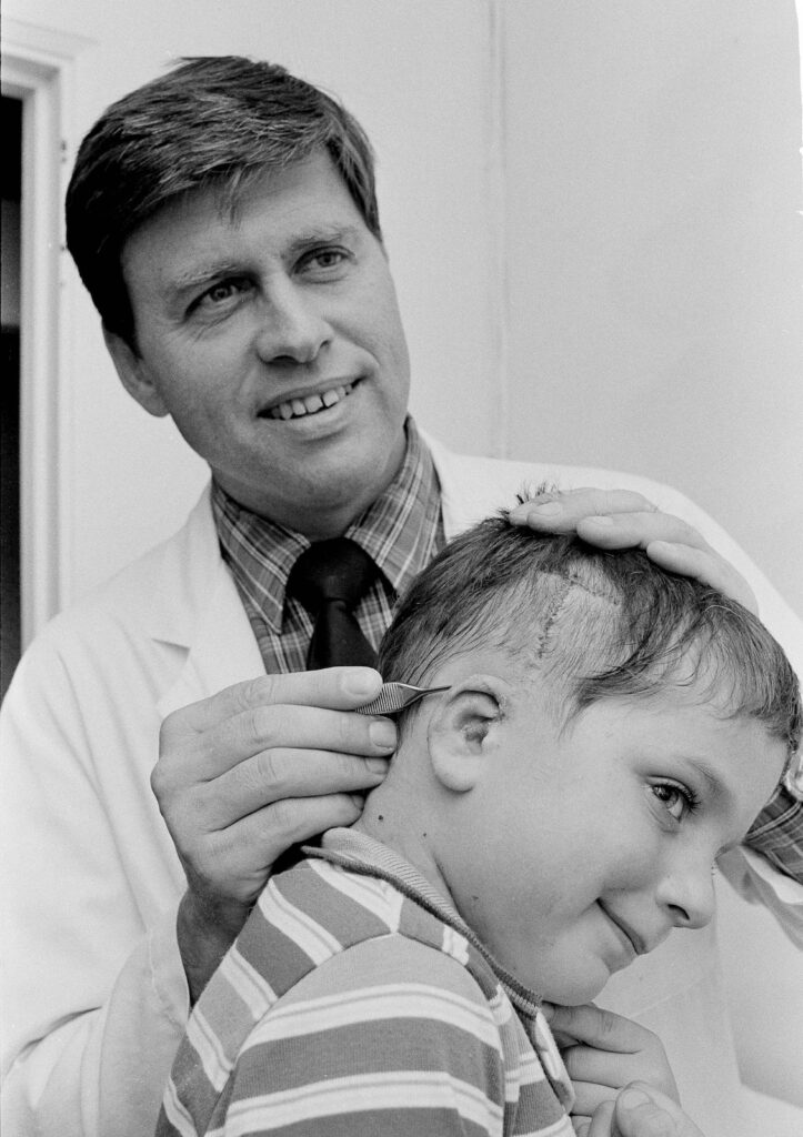 black and white photo of doctor and child