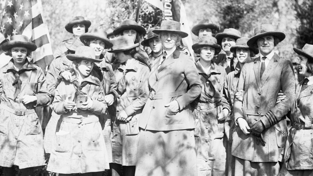 Photo of women and girls in uniform in the woods