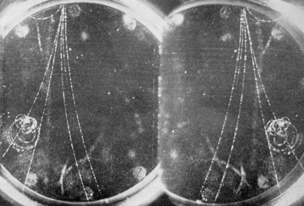 Bubble chamber image showing traces of subatomic particles