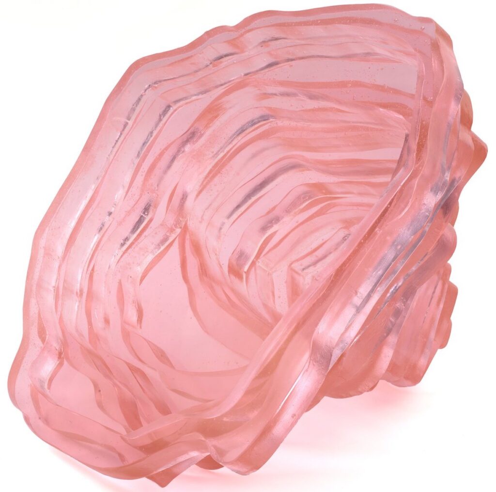 Pink layered translucent glass sculpture on a white background