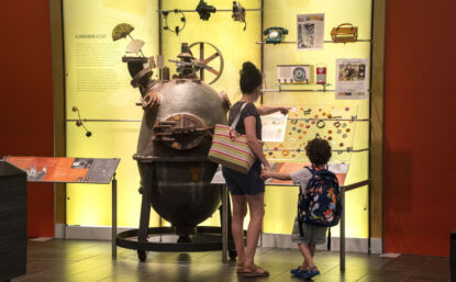 woman and child in front of a museum exhibit