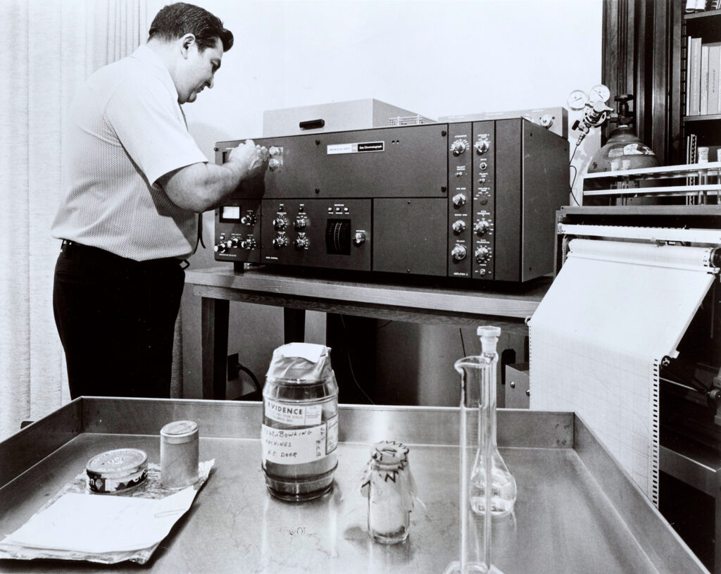 Black and white photo of man with scientific instrument