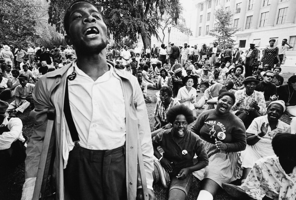 Black and white photo of a large group of people outside