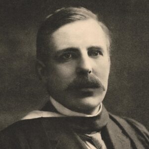 Rutherford with a thick mustache wearing a dark three-piece suit