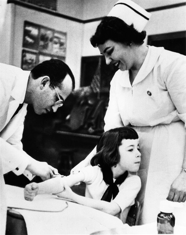 Jonas Salk and a nurse administering the vaccine. 