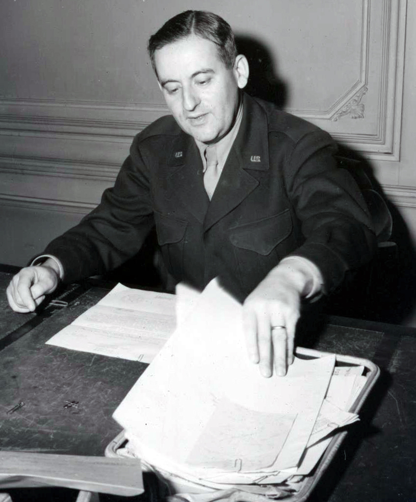 Man in uniform seated at desk