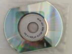 A shiny, reflective CD on top of a plastic sleeve