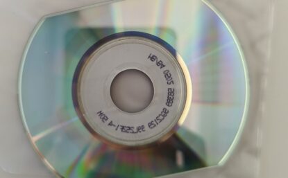 A shiny, reflective CD on top of a plastic sleeve