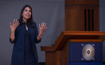 Photo of woman standing beside a lectern