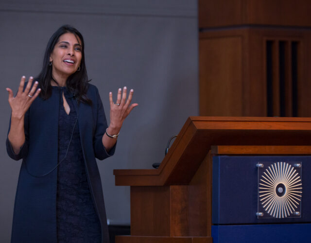 Photo of woman standing beside a lectern