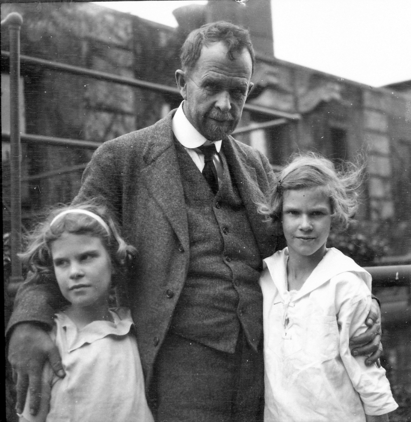 Black and white photo of father and two young daughters