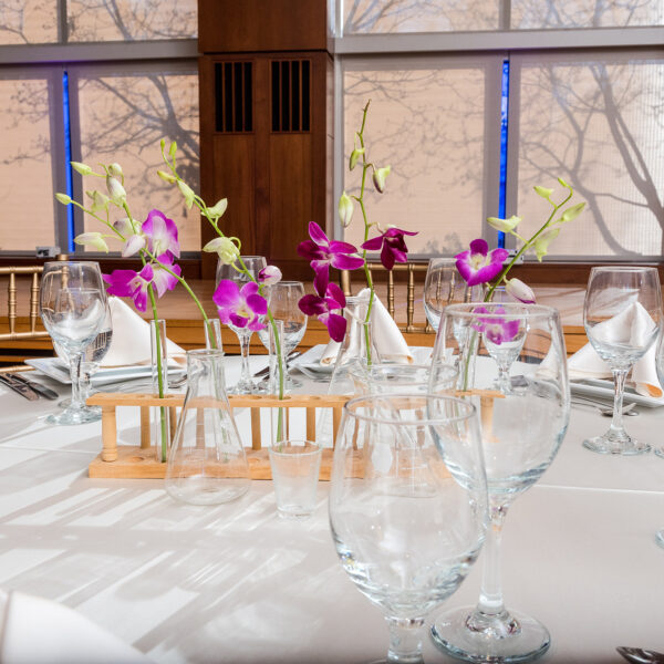 dining table with orchids and test tubes