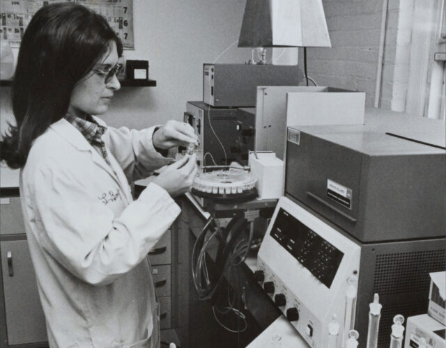 woman in lab coat testing samples